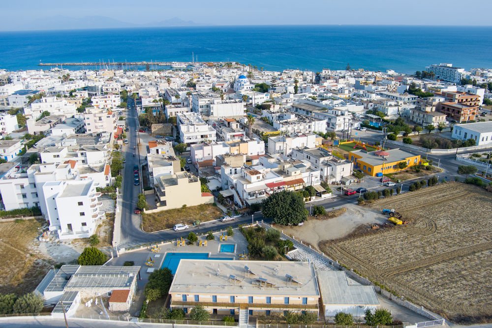 Aerial view of Kardamena town, its harbour and the Aegean Sea on Kos