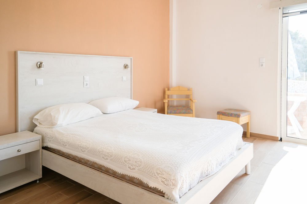 Spacious bedroom with a double bed and direct balcony access