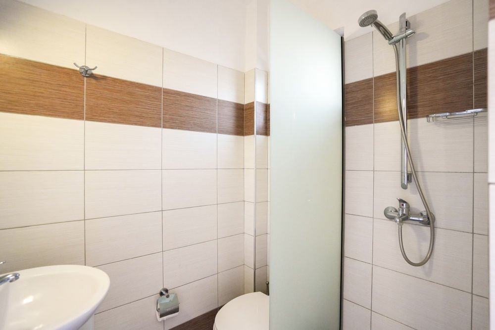 Shower with a glass screen in a Paraschos Studios bathroom