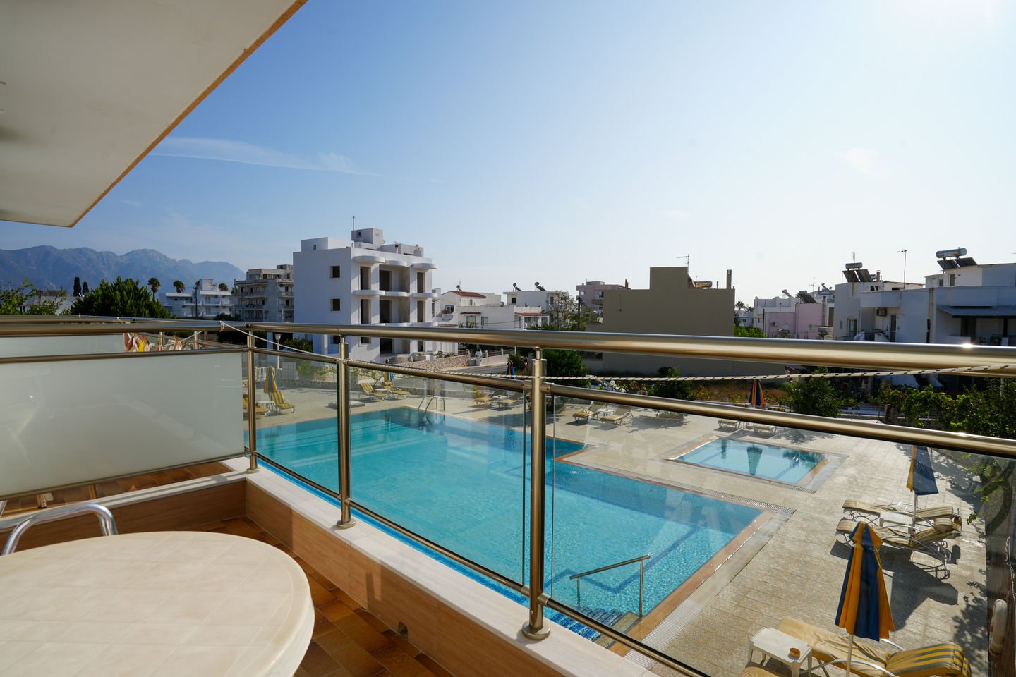 Studio balcony looking out over the pool and the mountains behind Kardamena