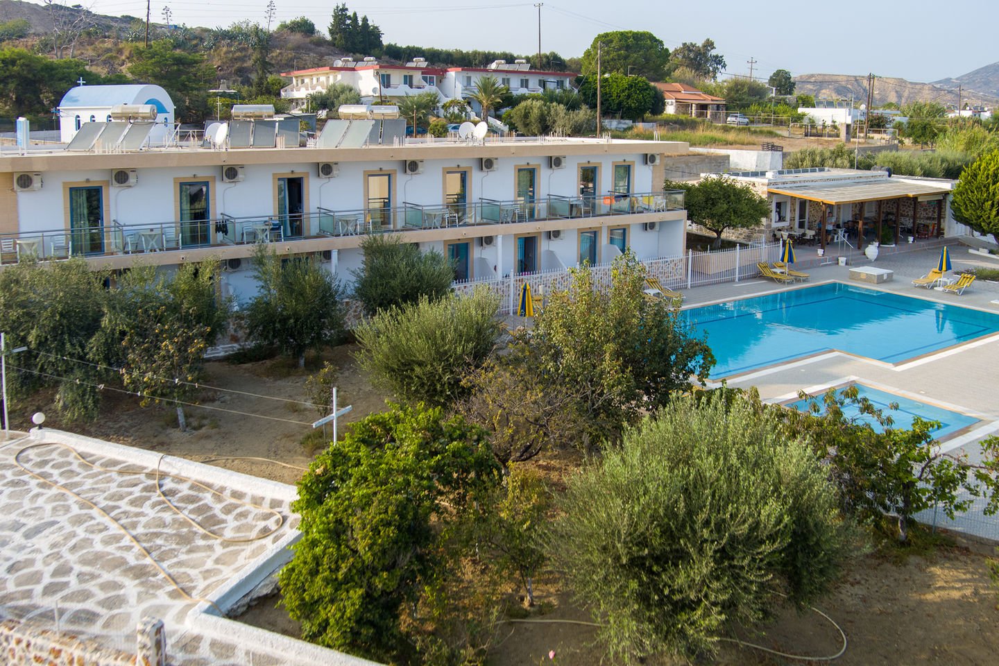 Aerial view of the Paraschos Studios building, its garden and swimming pool